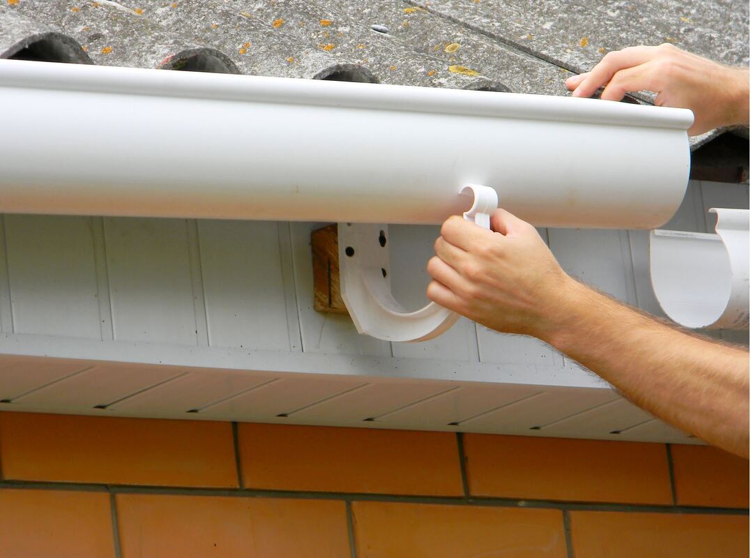 Contractor installing plastic guttering on a new home in Rydalmere